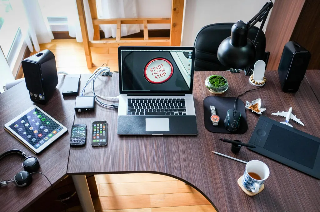 Laptop and multiple devices on desk used for software development testing